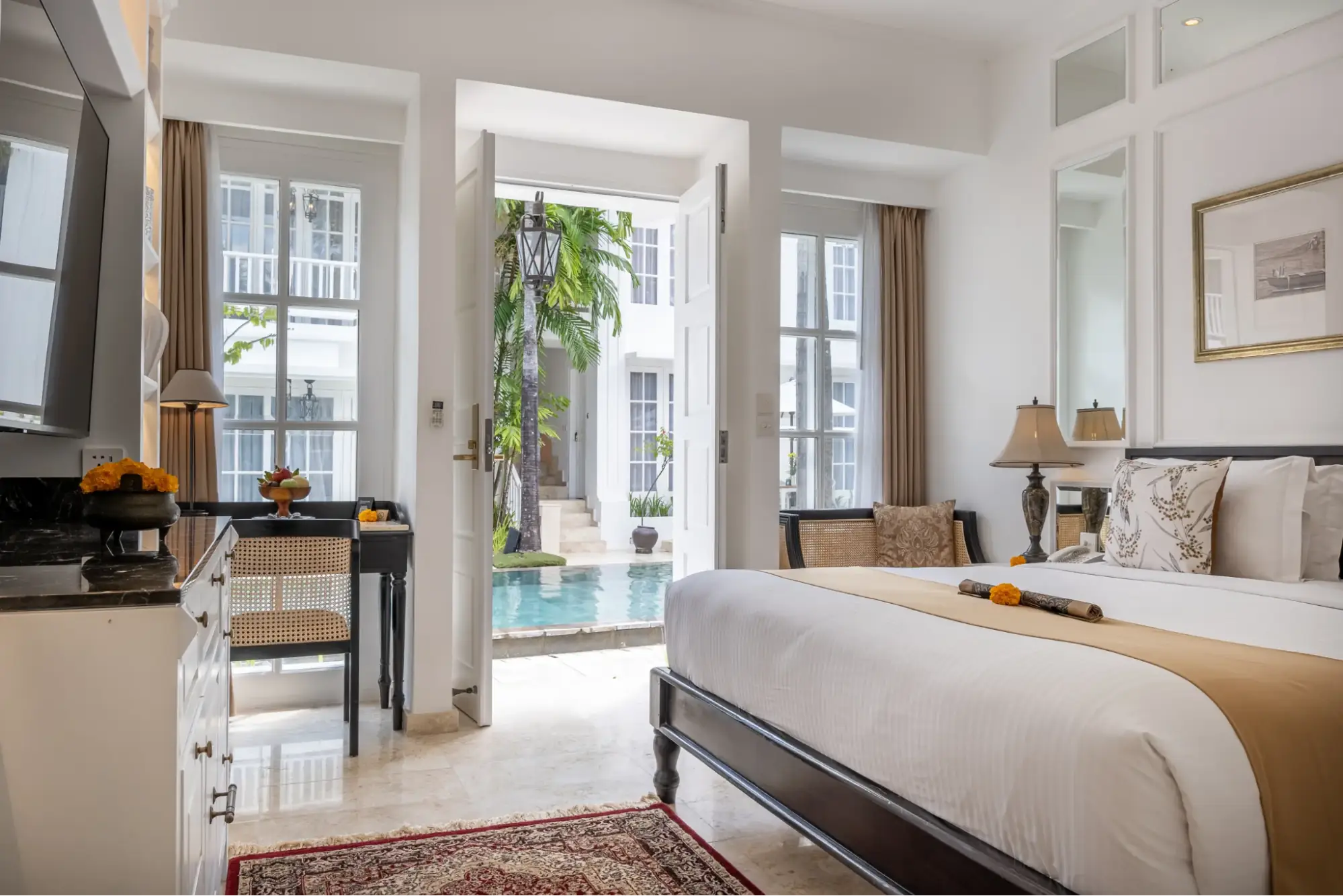 Deluxe Room at The Colony Hotel Bali, an adult-only accommodation in Seminyak, offering a peaceful pool view and stylish decor