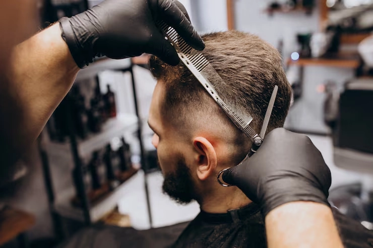 Professional barber giving a stylish haircut to a man at a modern barbershop in Bali