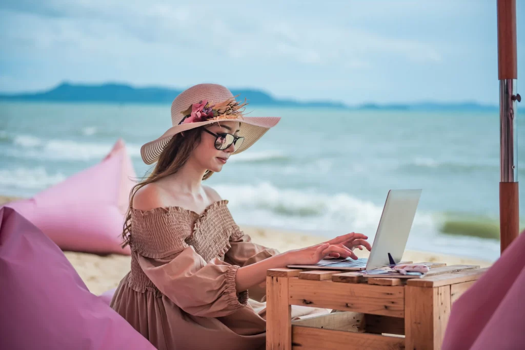 digital nomad working in bali with beach background