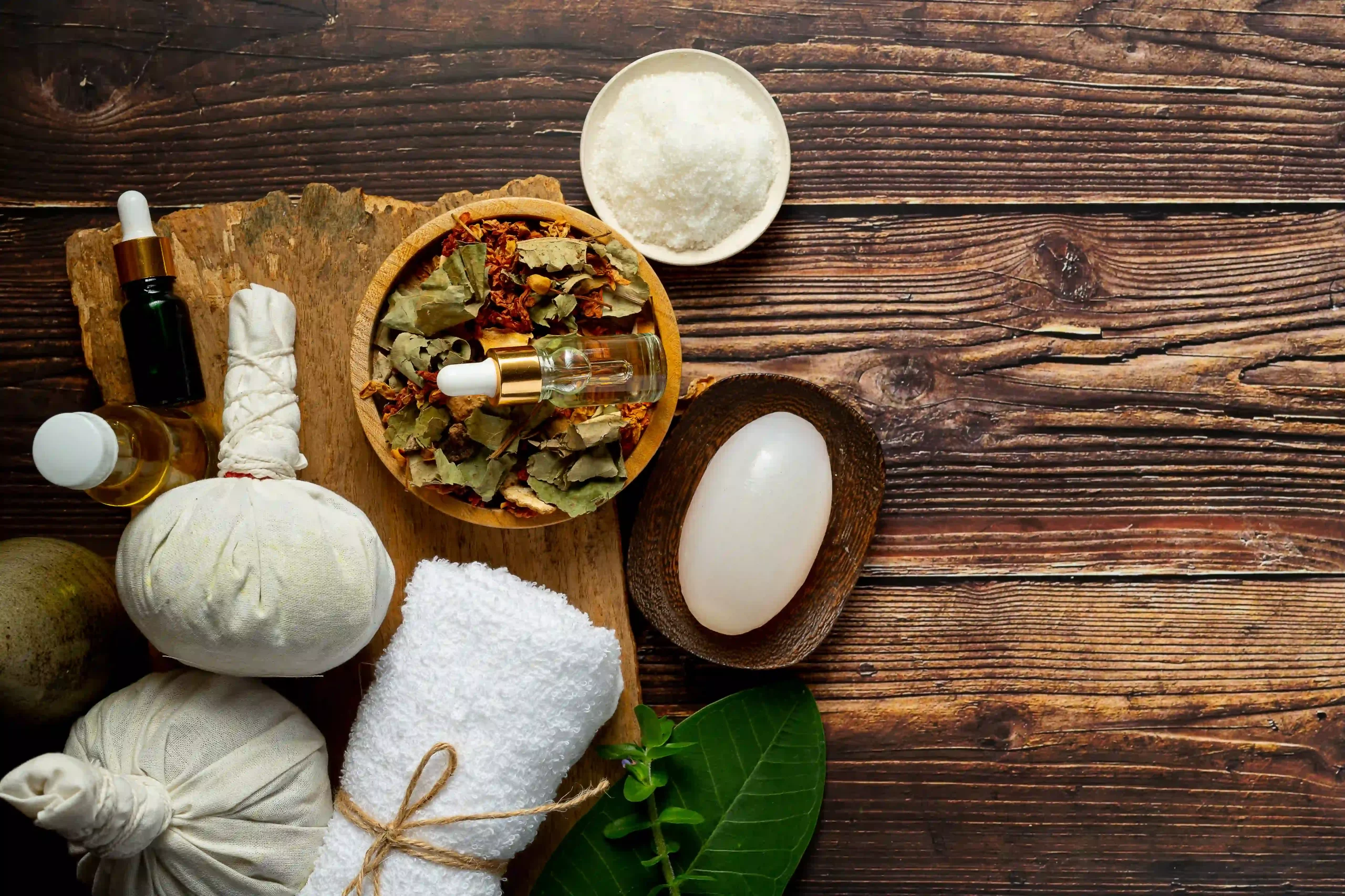 Flat lay of herbal poultice massage essentials