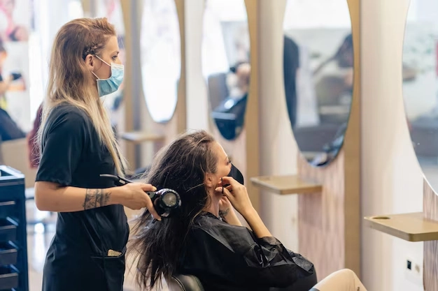 Professional hairstylist blow-drying a client’s hair at a modern salon in Seminyak