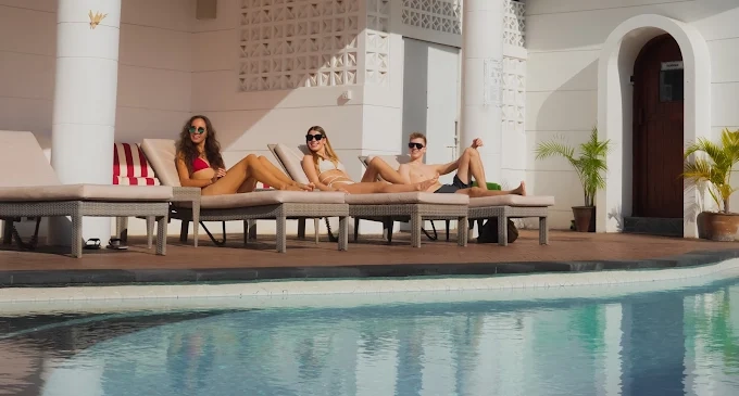 Poolside relaxation at AMO Spa Canggu, blending wellness treatments with a lively social setting