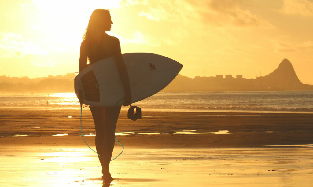 surfing at kuta beach, bali