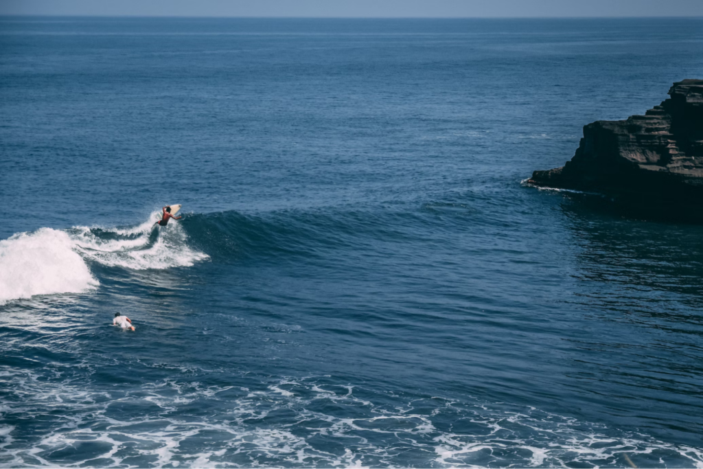 Person surfing on the ocean waves in Bali