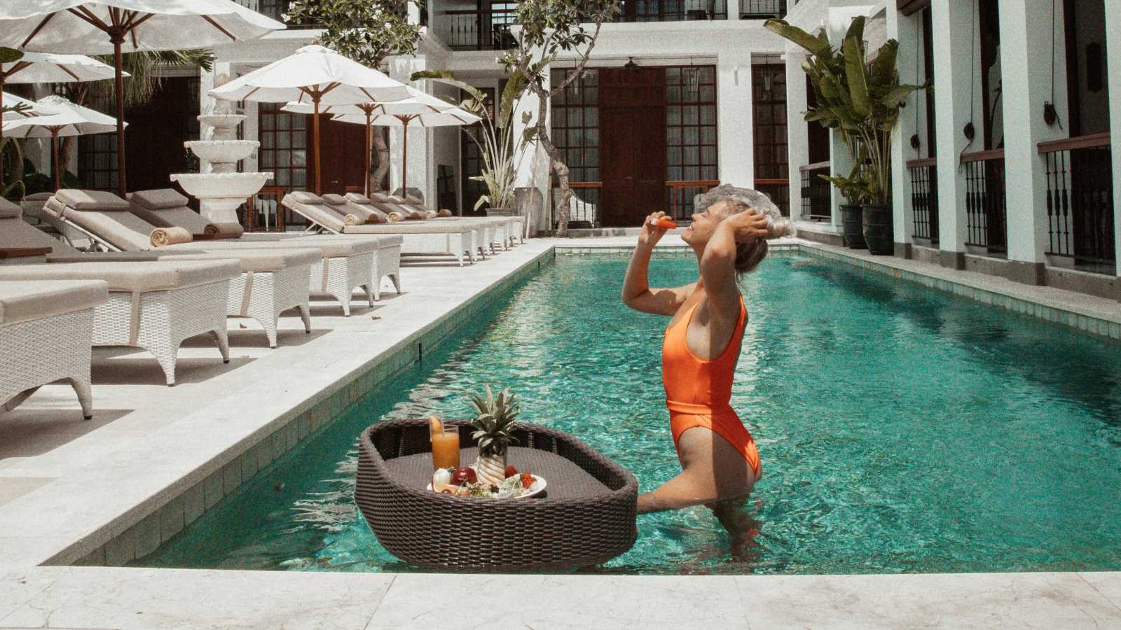 woman enjoying pool at the colony hotel bali