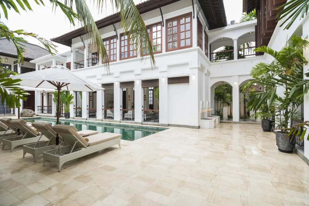 Pool area at The Colony Hotel Bali showcasing colonial-style architecture