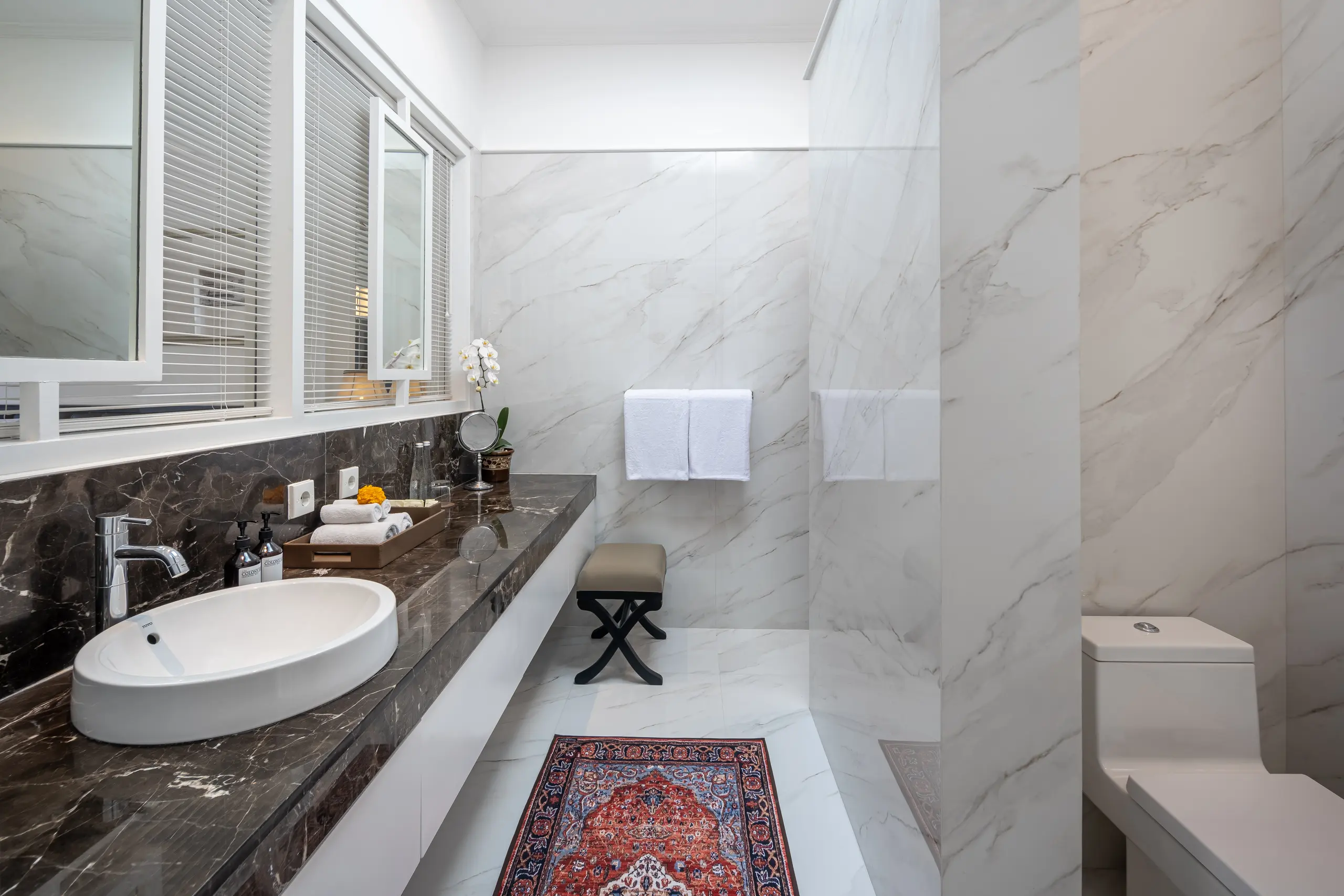 Spacious and clean bathroom with full equipment in Deluxe Room at boutique accommodation The Colony Hotel Bali, Seminyak.