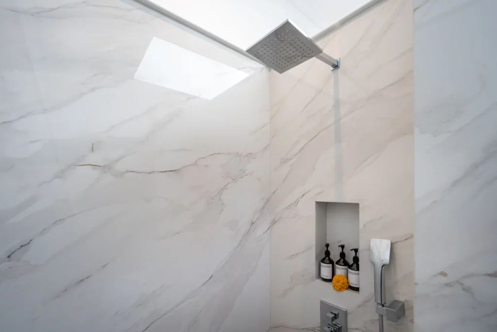 Spacious and clean bathroom with full equipment in Deluxe Room at boutique accommodation The Colony Hotel Bali, Seminyak.