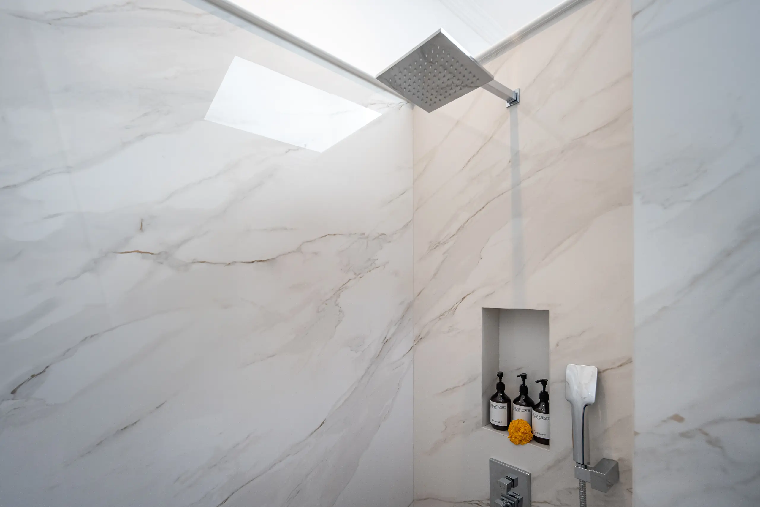 Clean and sleek shower area in Deluxe Room at The Colony Hotel Bali, boutique accommodation Seminyak.