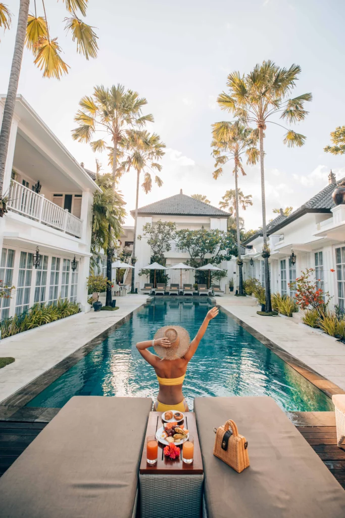 Relaxed woman at the poolside of The Colony Hotel, a stylish boutique hotel