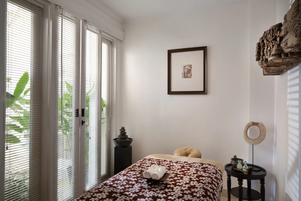 Massage Room at The Colony Hotel Bali Featuring Massage Bed, Elegant Decor, and Soft Lighting