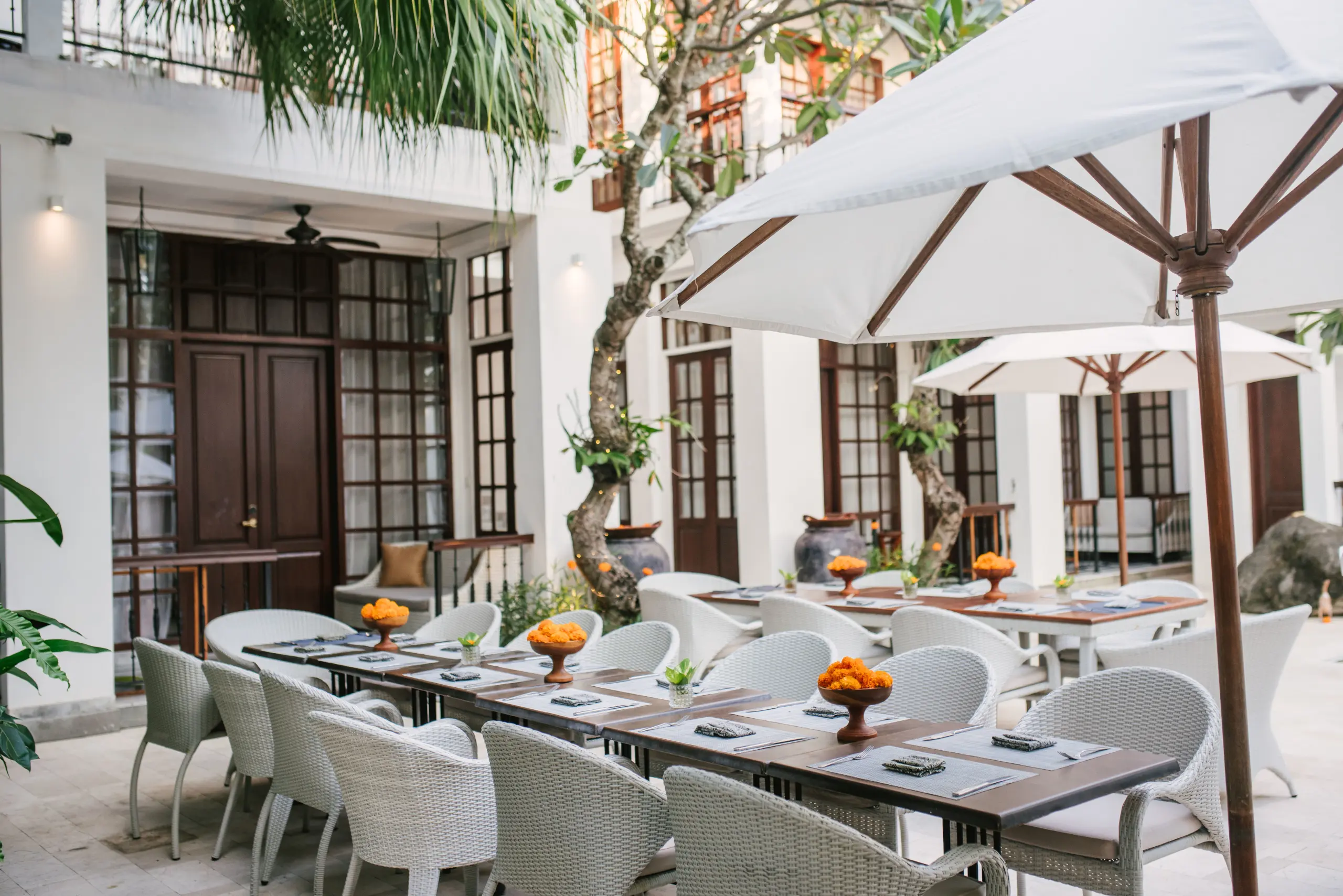 Outdoor Table Setup by the Pool at The Colony Hotel Bali, a Boutique Hotel Seminyak