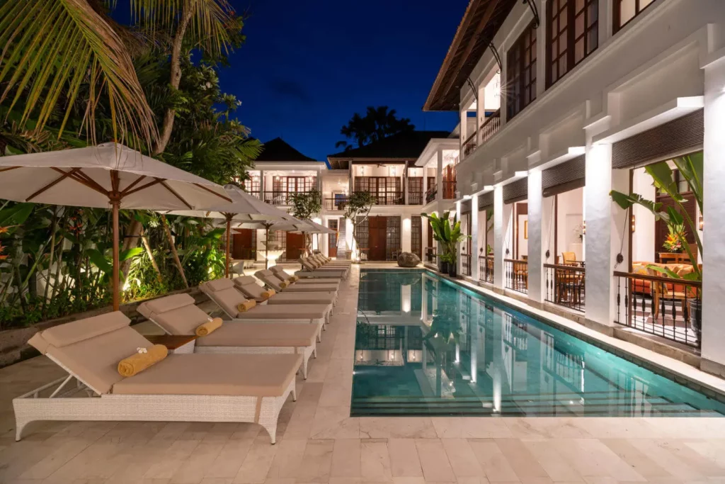 Serene nighttime view of the pool at The Colony Hotel Bali