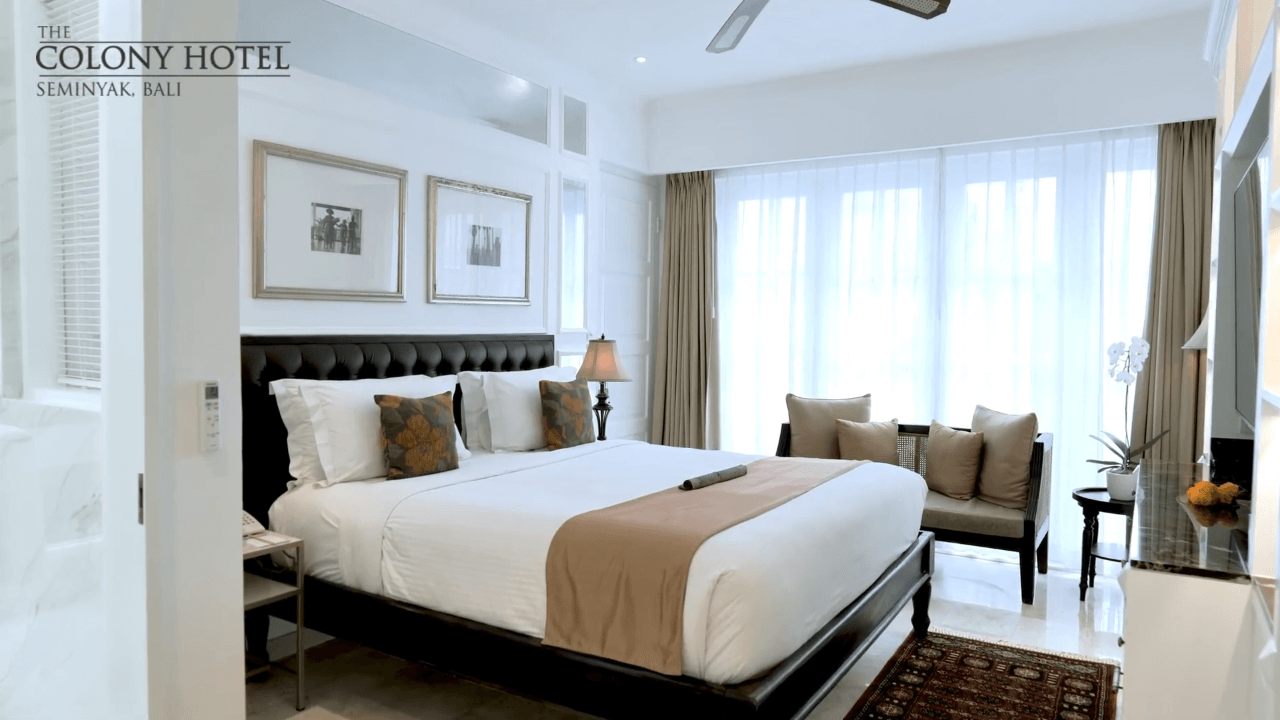 Premier Room interior showing comfortable bed and sofa seating at The Colony Hotel Bali