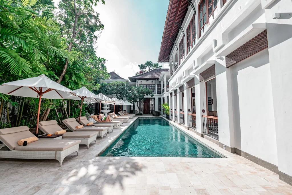 Sun Lounges by the Pool with Hotel Architecture in Background at The Colony Hotel Seminyak