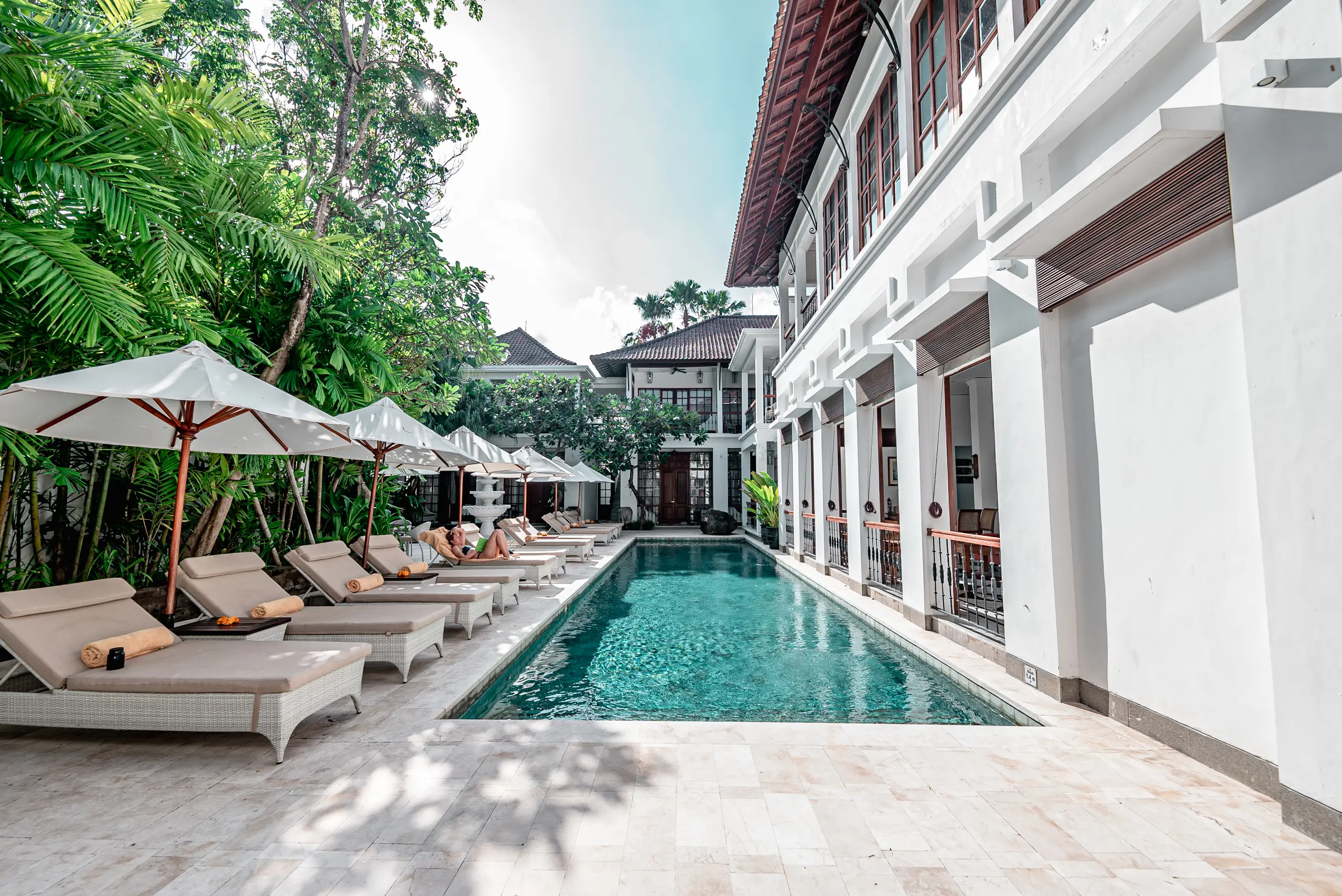 Sun Lounges by the Pool with Hotel Architecture in Background at The Colony Hotel Seminyak