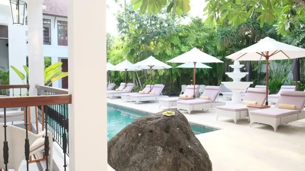 Relaxing Sun Lounges by the Pool Area at The Colony Hotel Seminyak, Bali Boutique Stay