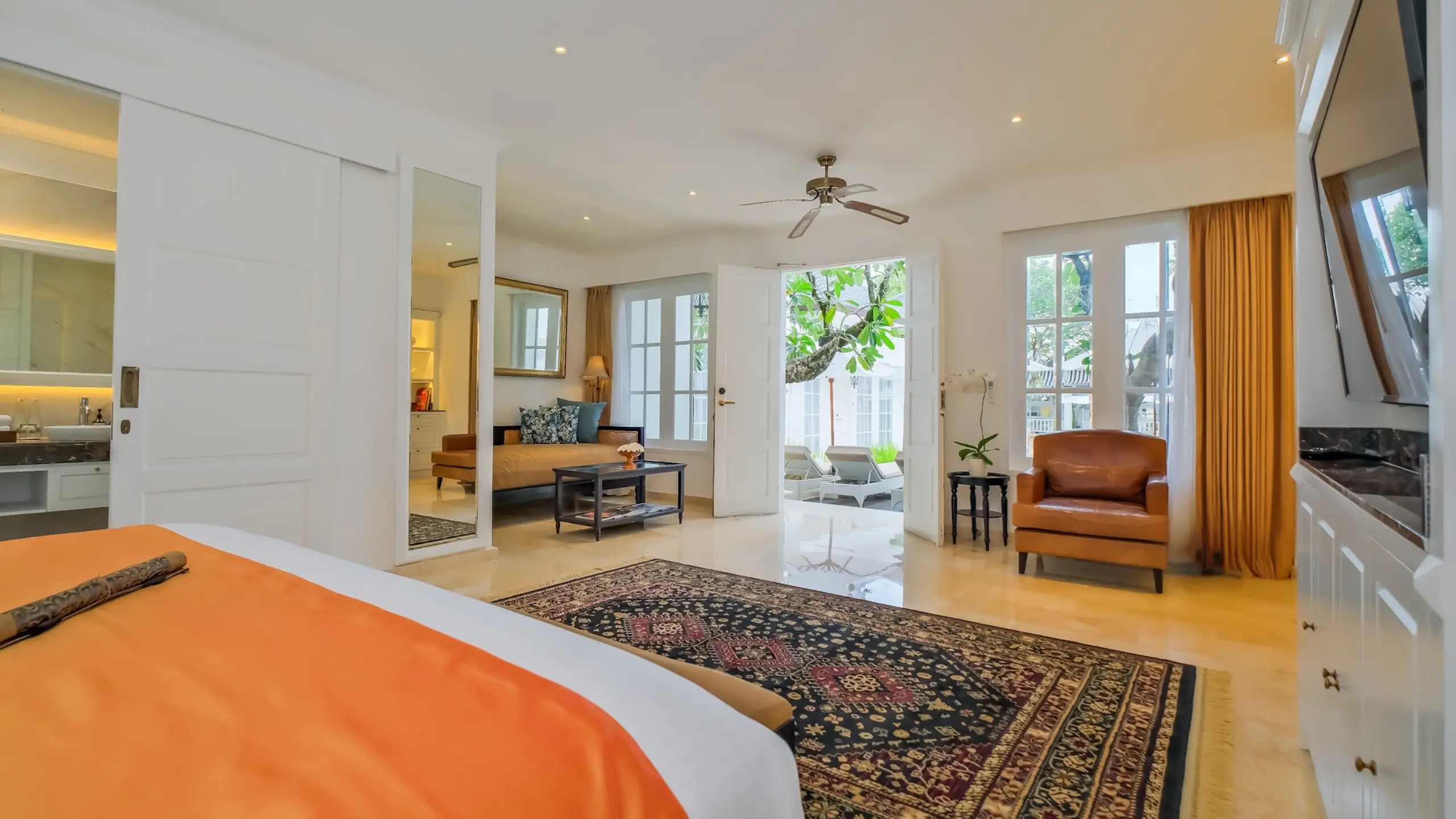 The Colony Hotel Bali’s Junior Suite with outdoor view and colonial-style architecture