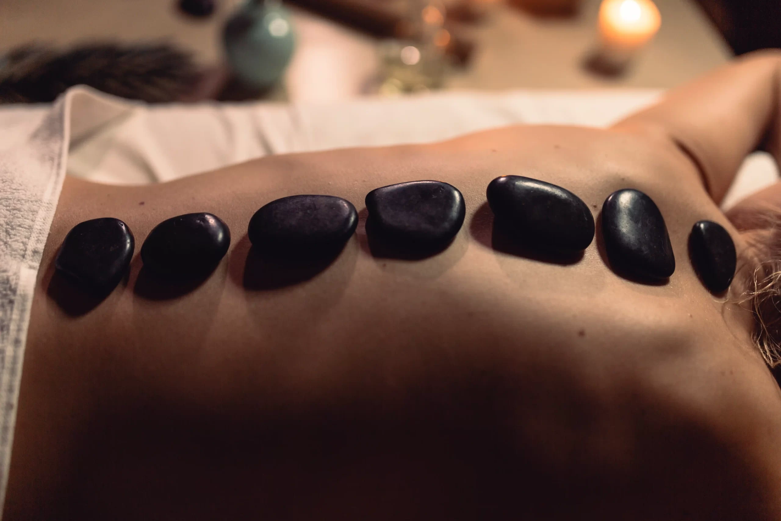 Hot stone massage therapy, one of the relaxing types of massage you can experience in Bali