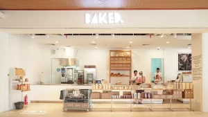Interior view of BAKED. bakery storefront with staff behind the counter