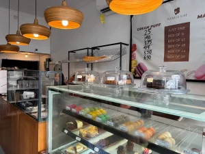 Poule de Luxe bakery interior showing macaron display and natural wooden lights